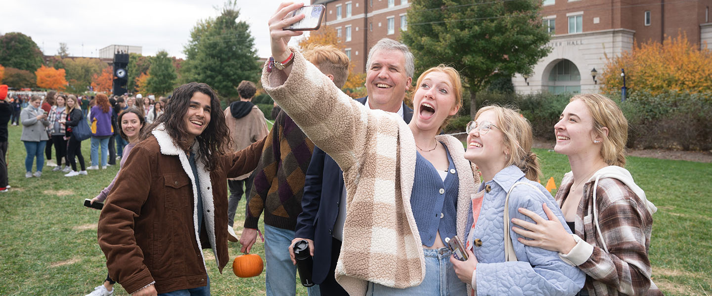 President Greg Jones taking a selfie with students