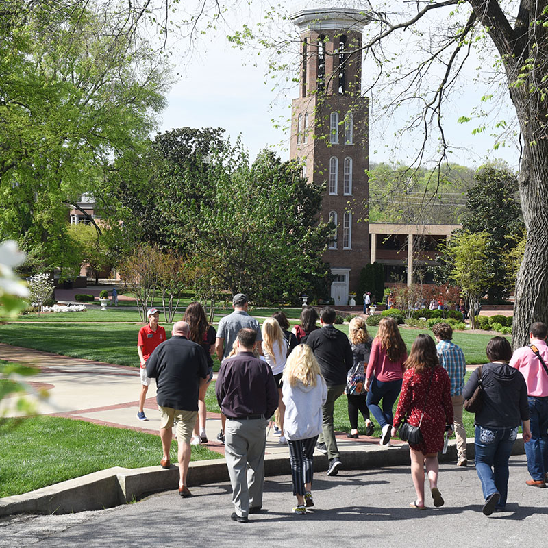 A tour guide taking families on a tour of campus