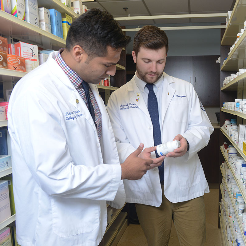 Two pharmacy students discussing a medication
