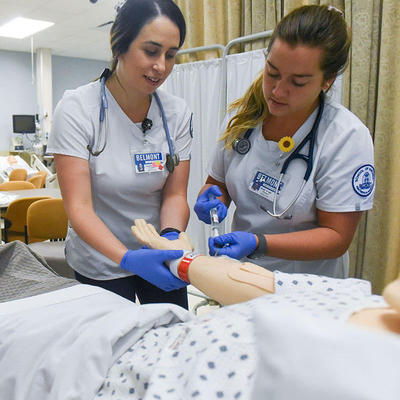 Two Nursing Students working in a simulator