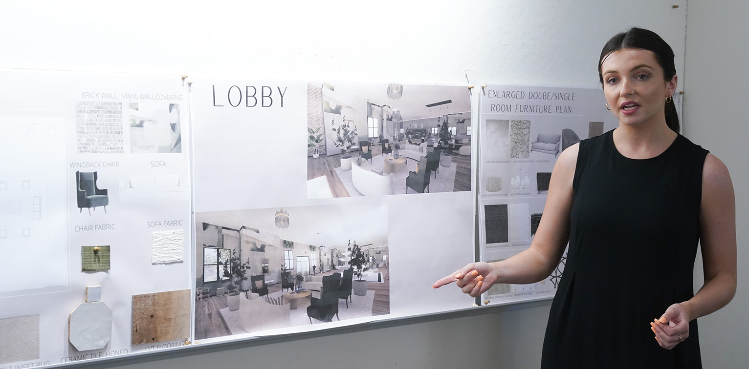 A female student presents a mood board of design styles.