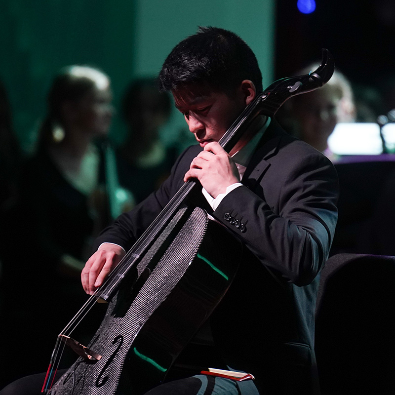 A male student plays the cello.