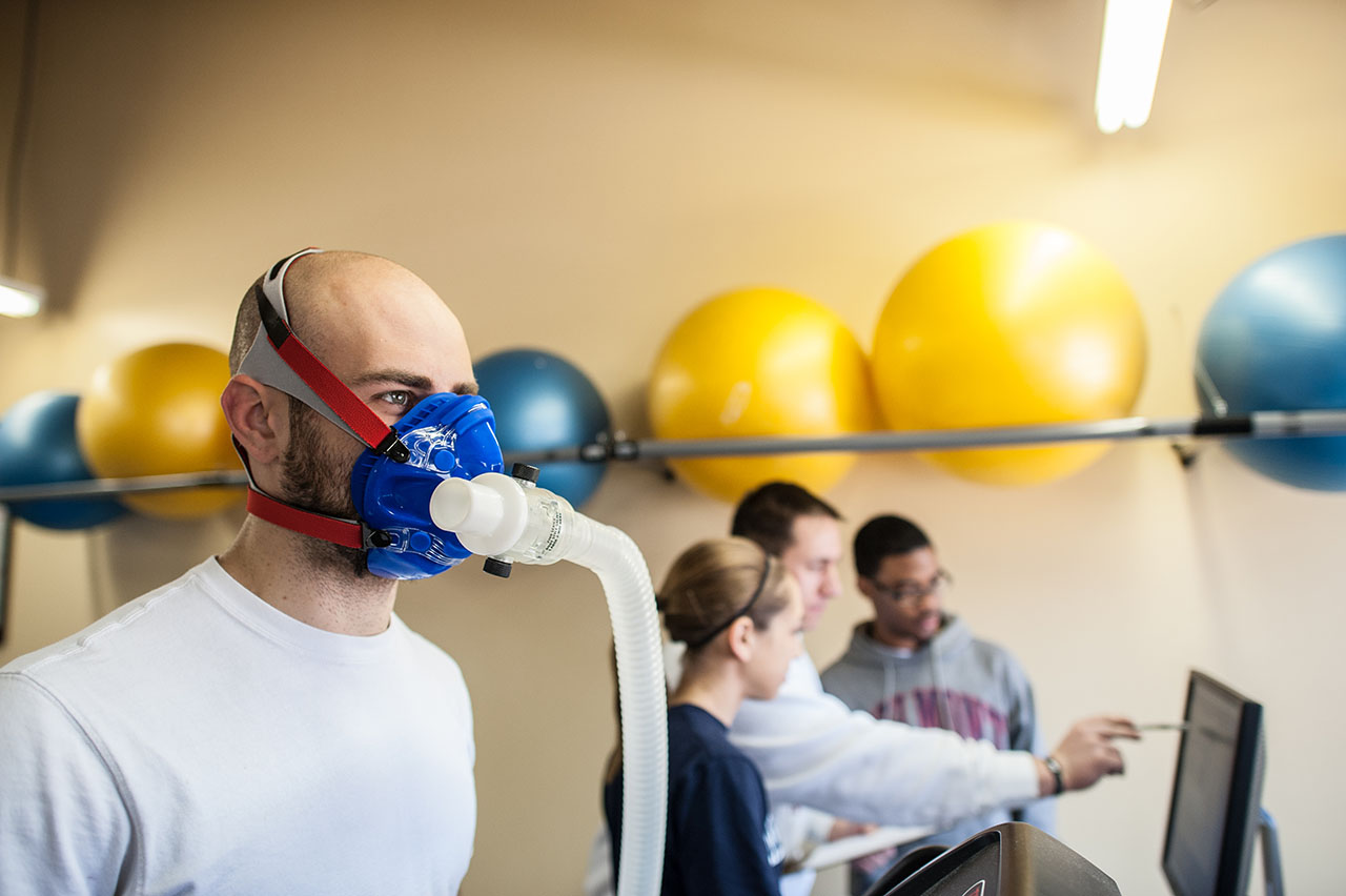 A student runs on a treadmill with a mask to measure their VO2 Max