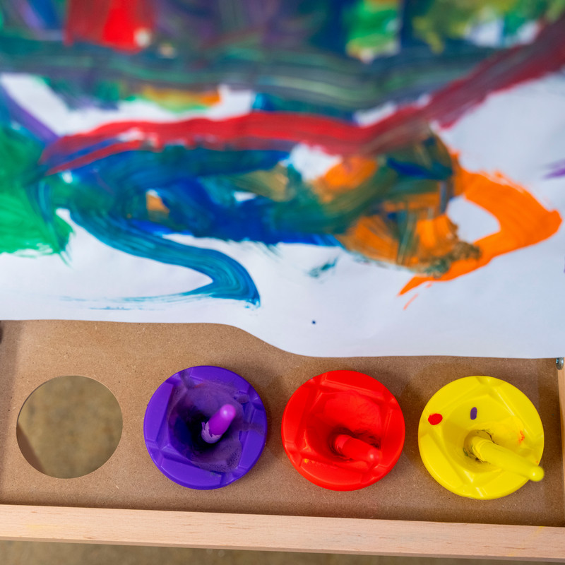 Close up of child's finger painting on a wooded easel 