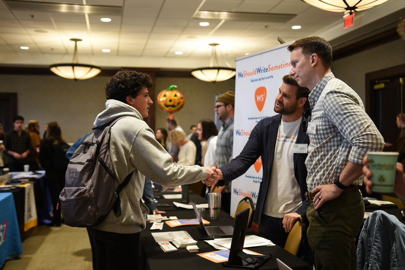 student shaking hands with recruiter 