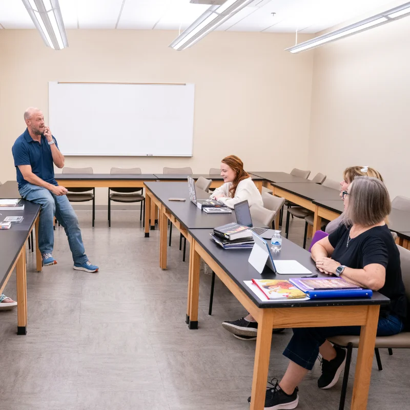 Professor leads graduate creative writing class.