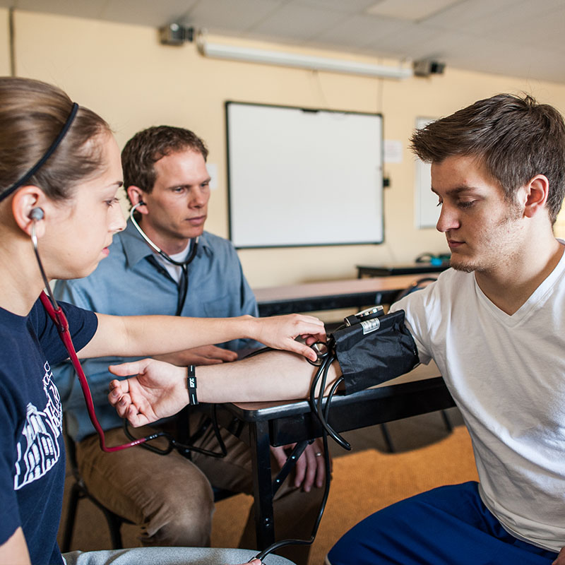 Exercise Science students takes the blood pressure of another student