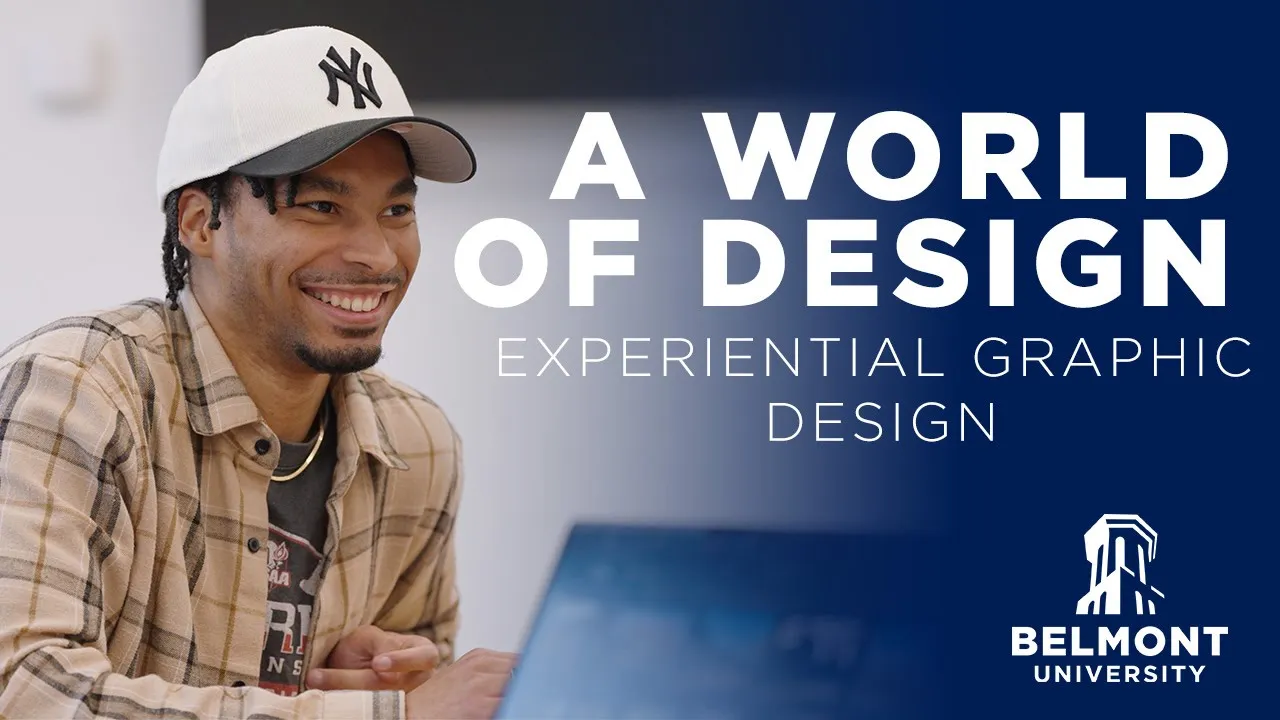 A student wearing a plaid shirt and a cap smiles while working on a laptop. Text on the image reads: "A World of Design – Experiential Graphic Design" with Belmont University branding.