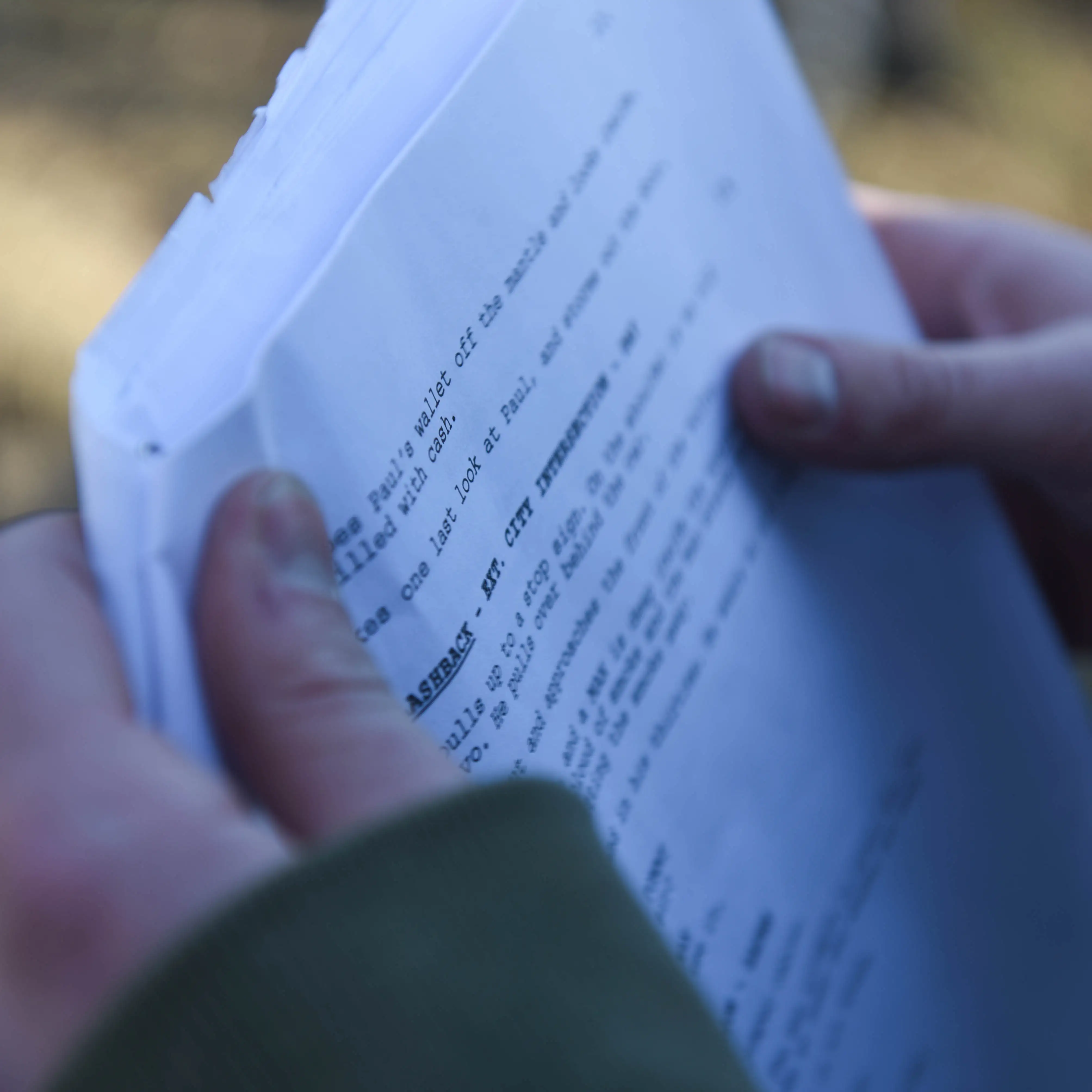 Hands holding a script