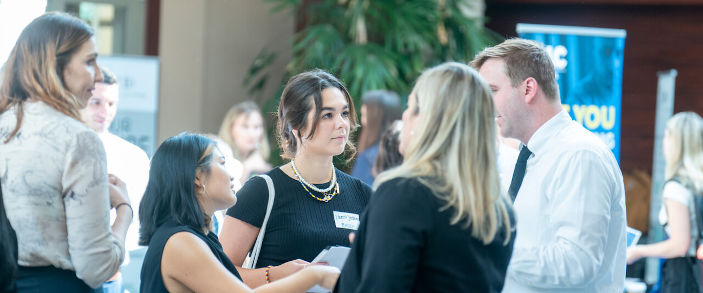 students talk with employers at a career fair