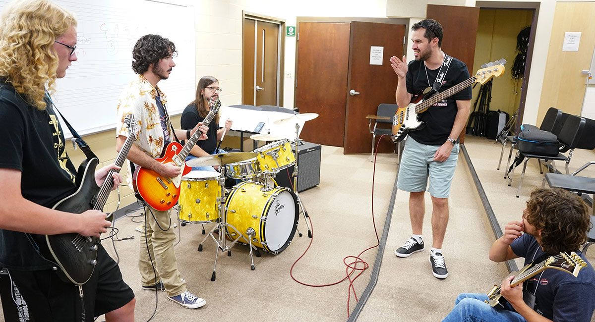 Music Profession teaches guitar and drum students