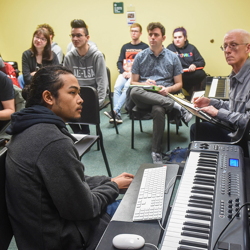 Music Technology students learning from professor in classroom