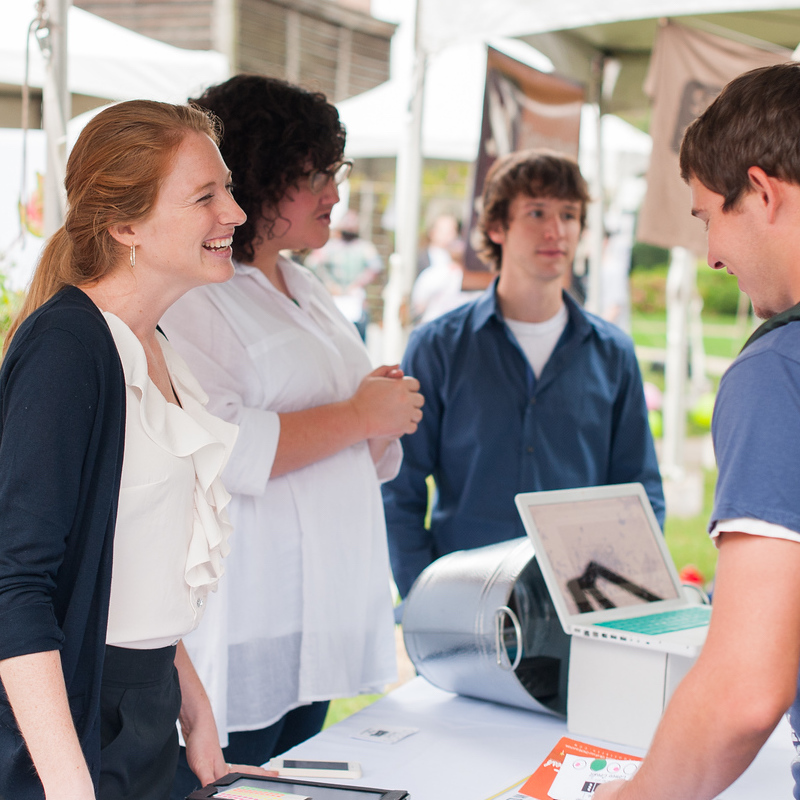 Potential employers talk to students during outdoor job fair