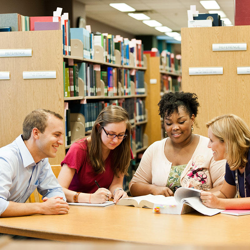 Graduate students working together in the Library