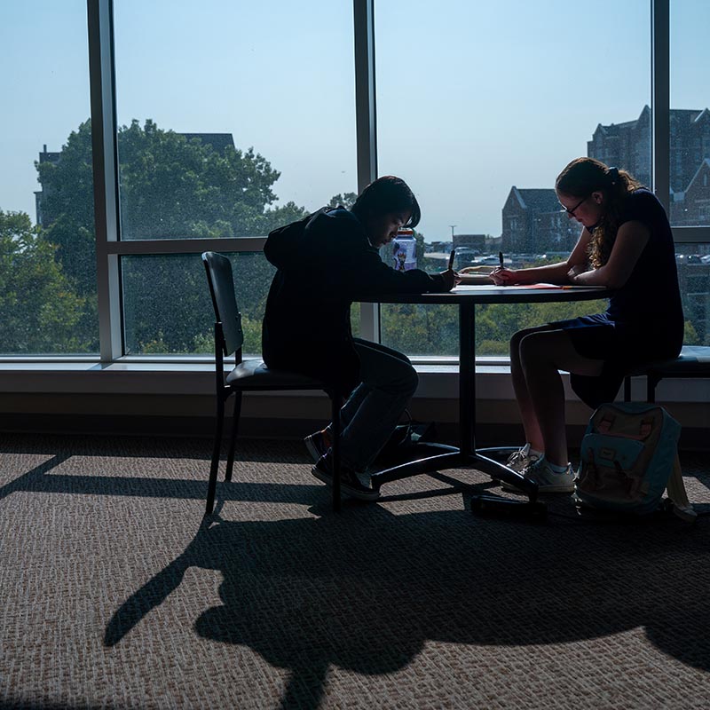 Two students sitting at a table working on project in the JAAC 