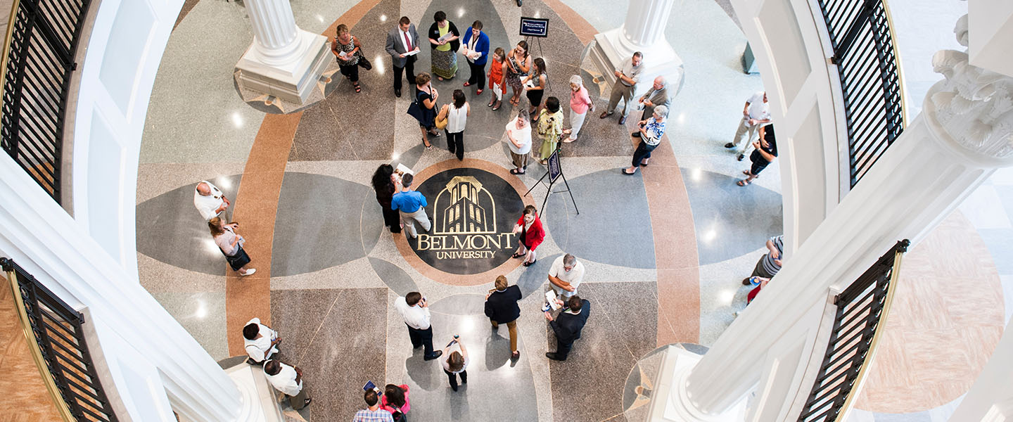 View of the Barkley Grand Atrium with a crowd of people and the Belmont logo