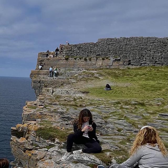 Students enjoying the views off the cliffs of Ireland