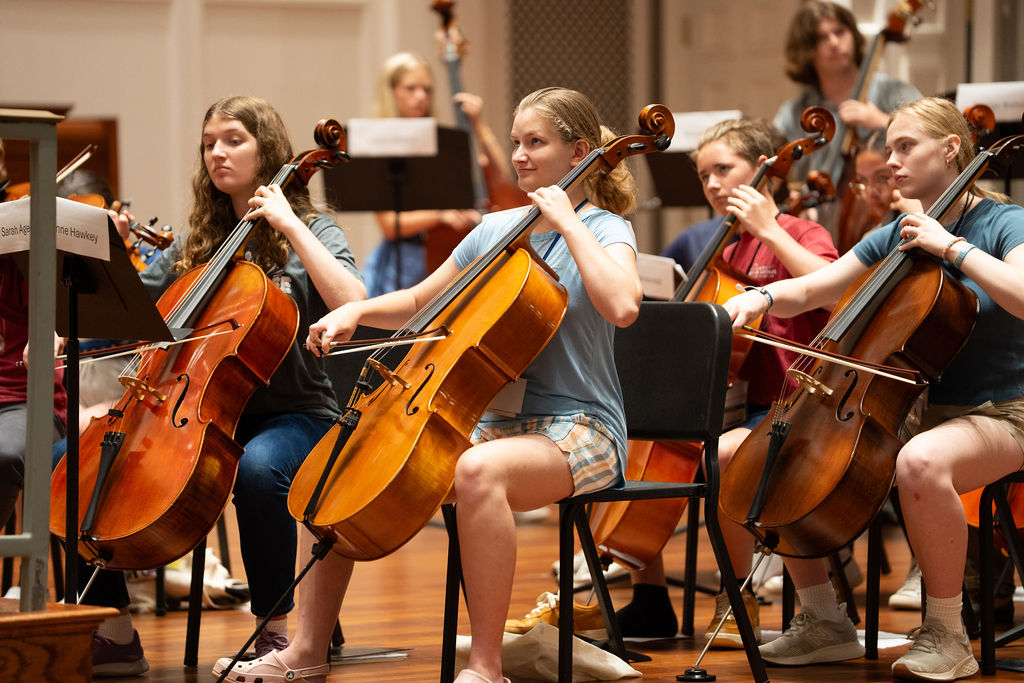 Summer camp students participate strings class