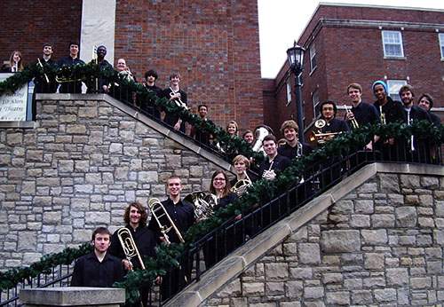 Chamber Brass Choir Ensemble posing for picture in front of McAfee Concert Hall