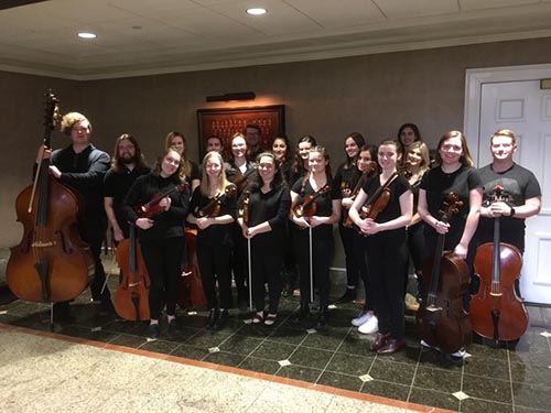 Strings Orchestra Ensemble pose for pictures backstage with their instraments