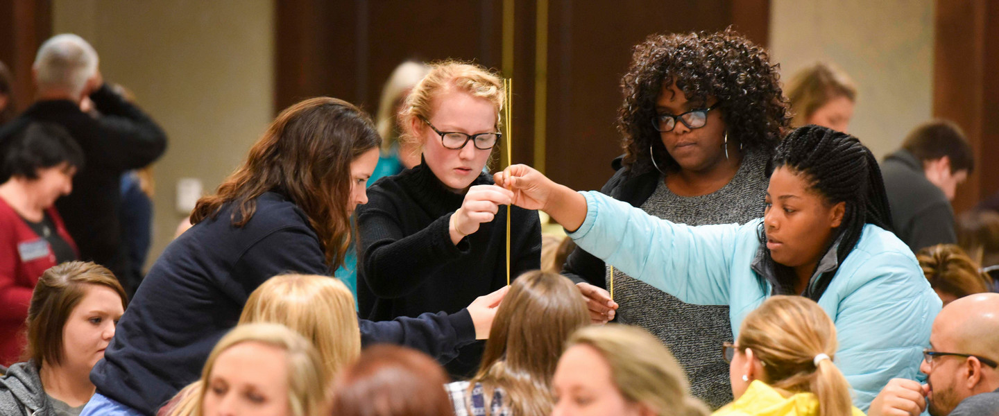 Student working together to build a tower during an Interprofessional engagement event 