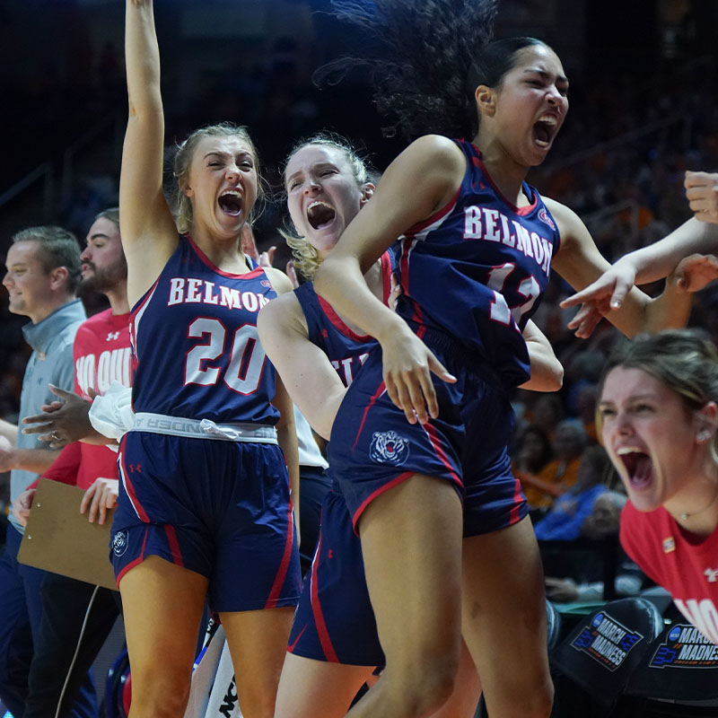Women's basketball players cheer as they win a championship