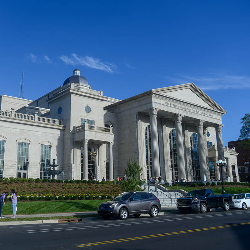 Outside of the Fisher Center for Performing Arts building on a sunny day