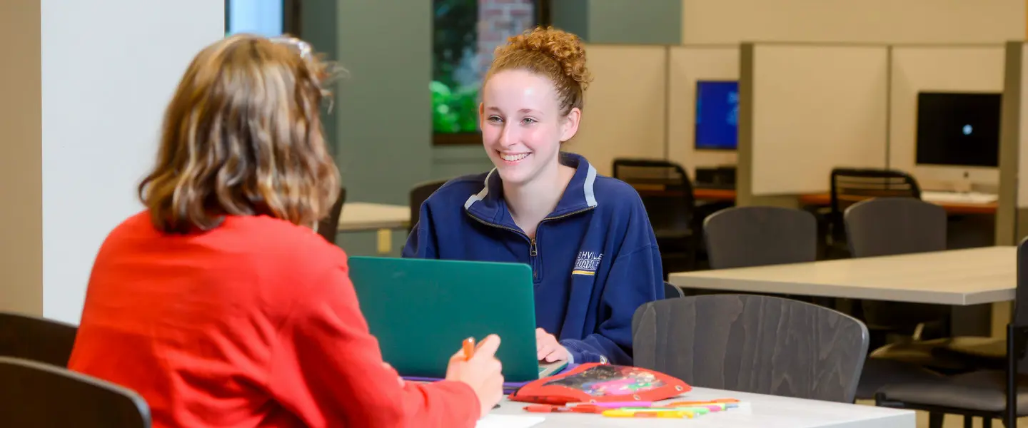 Students studying and talking together at Lila D. Bunch Library.