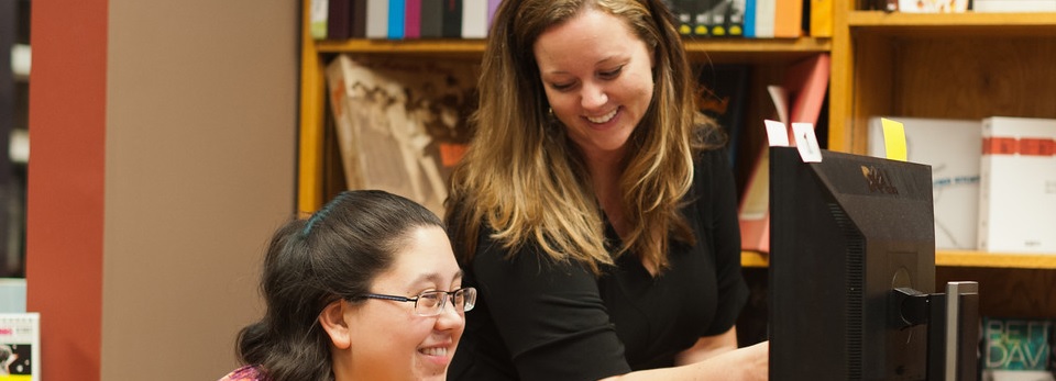 Claire Wiley assisting a student with her questions