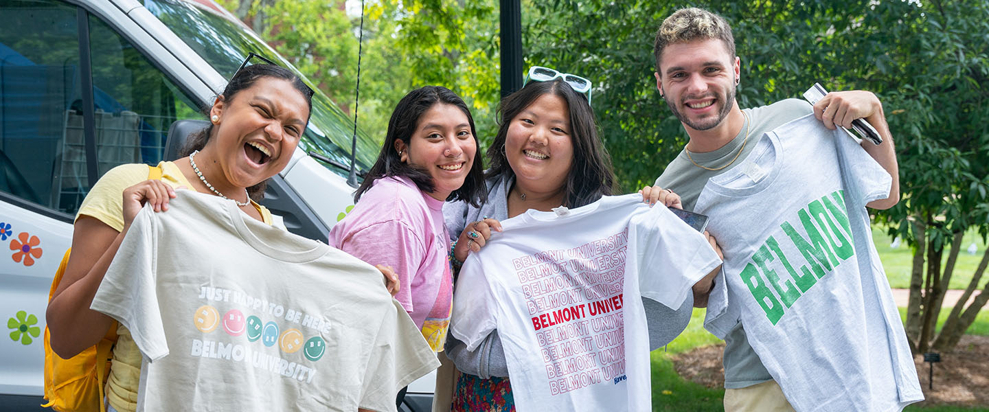 Four students posing with Belmont shirts on a Food Truck Friday