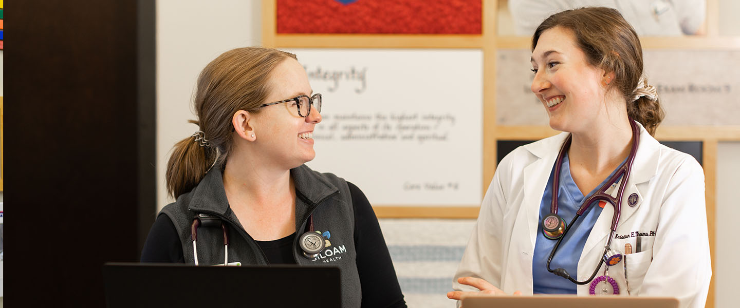 medical student talks with a nurse at a clinic 