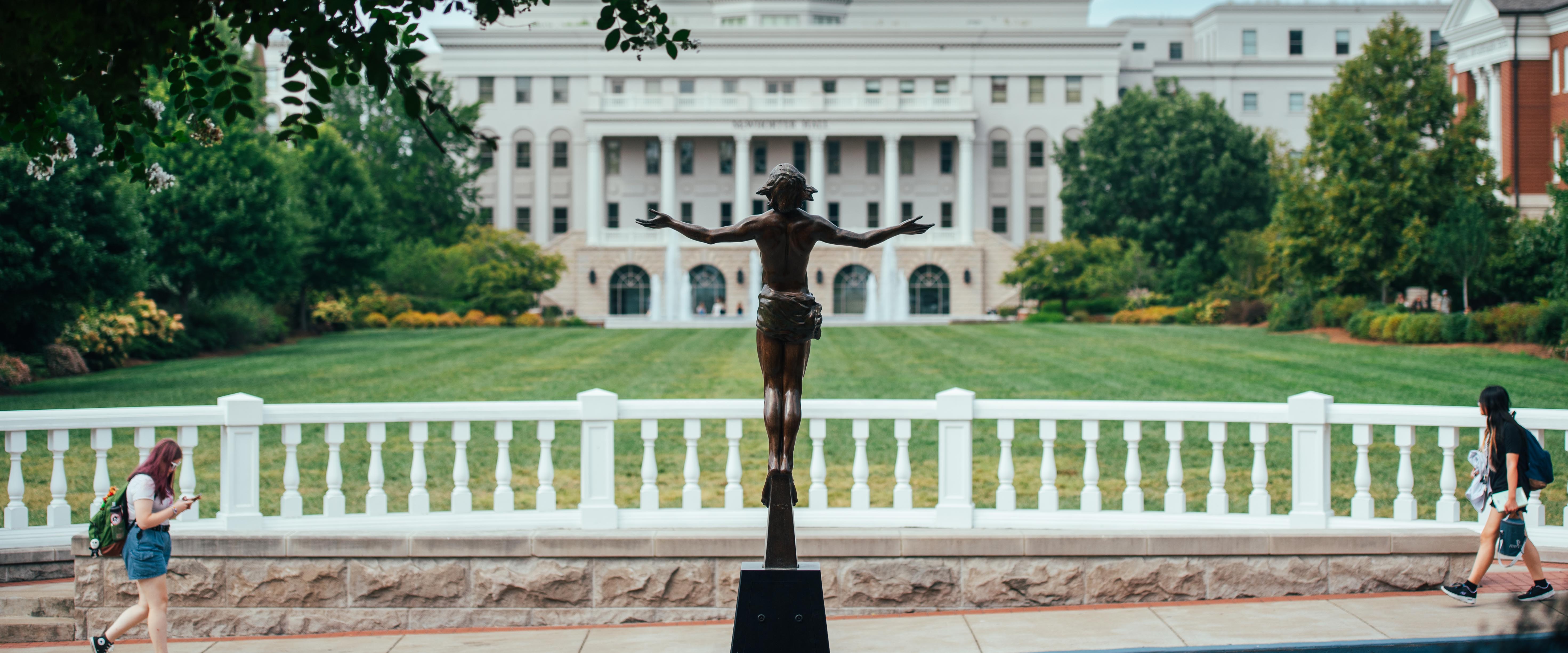 Back of the statue of Jesus rising on with a view of the south lawn