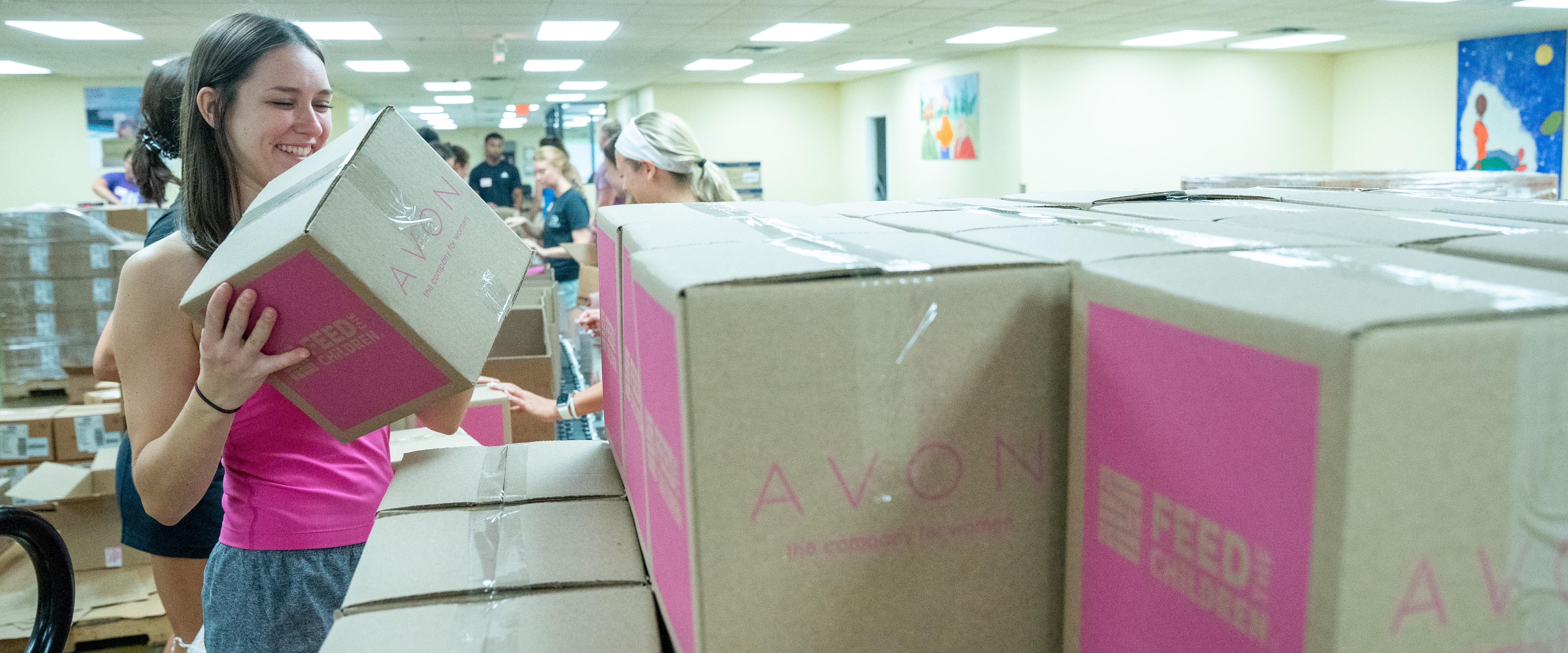 Students volunteer at Feed the Children packing boxes