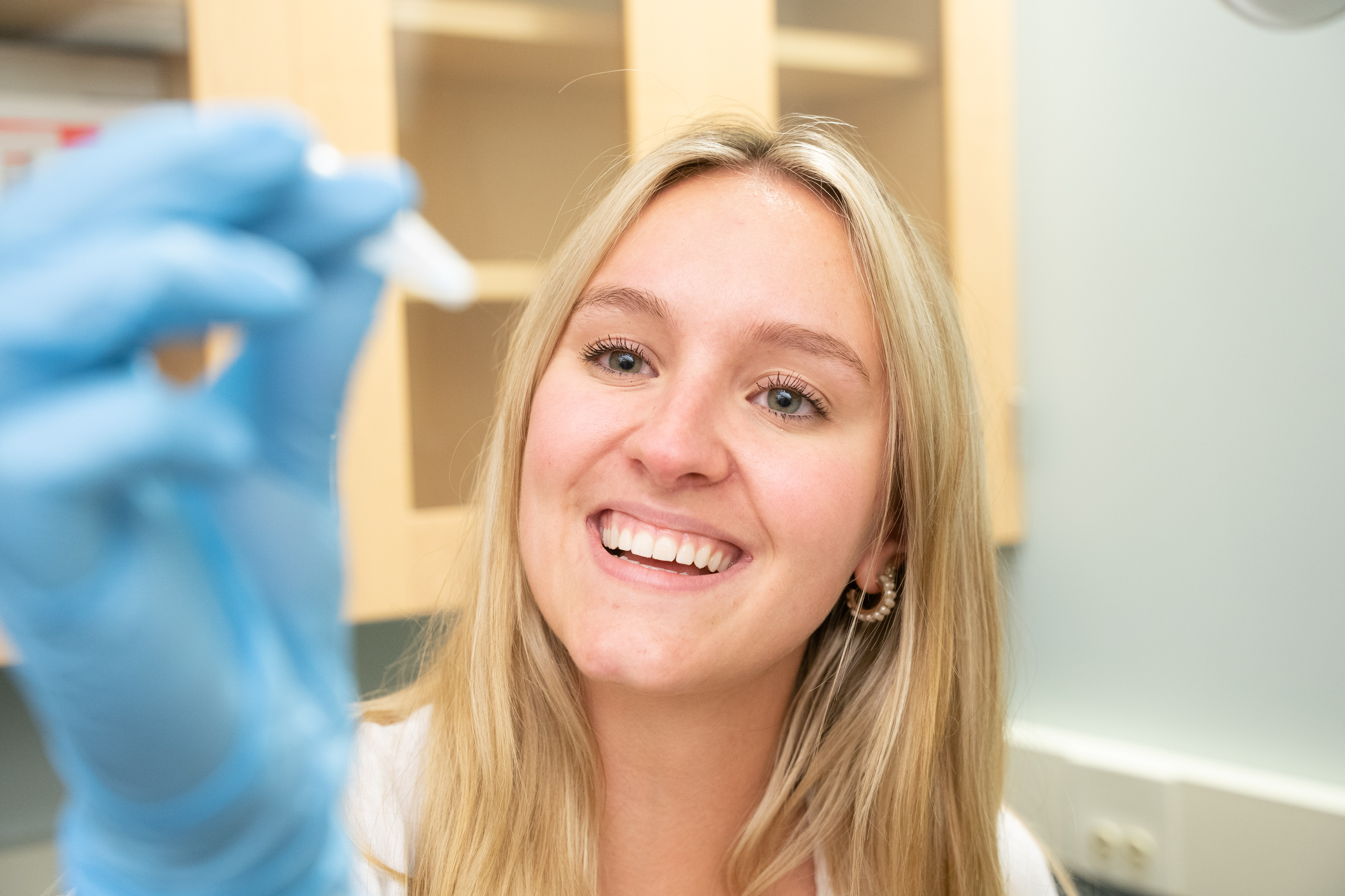 student looking at test tube