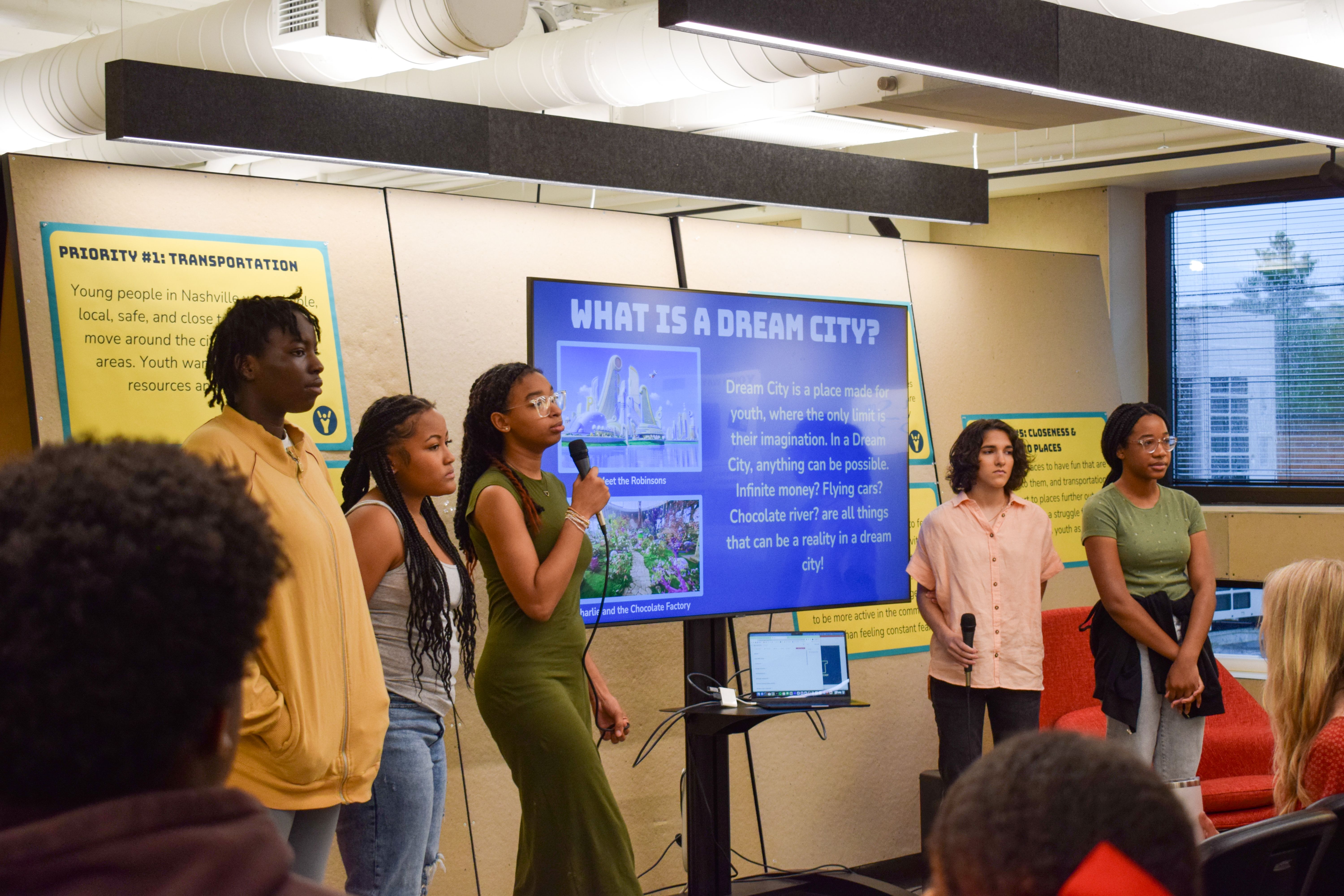 Five students from the Nashville Youth Design Team present in front of a screen
