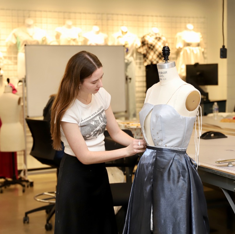 Fashion student working on project, a grey dress