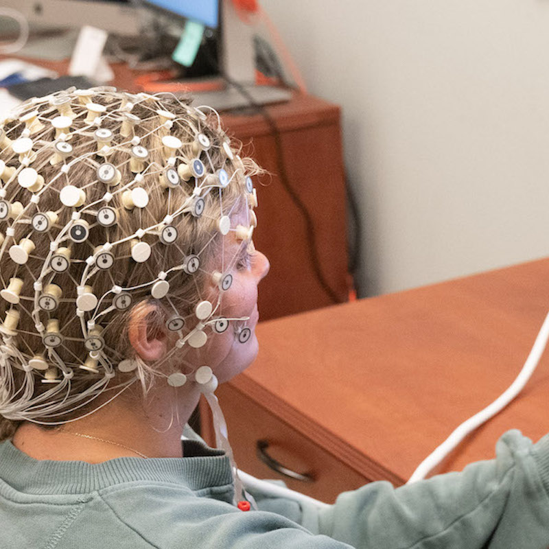 Psychology students completes test while wearing EEG
