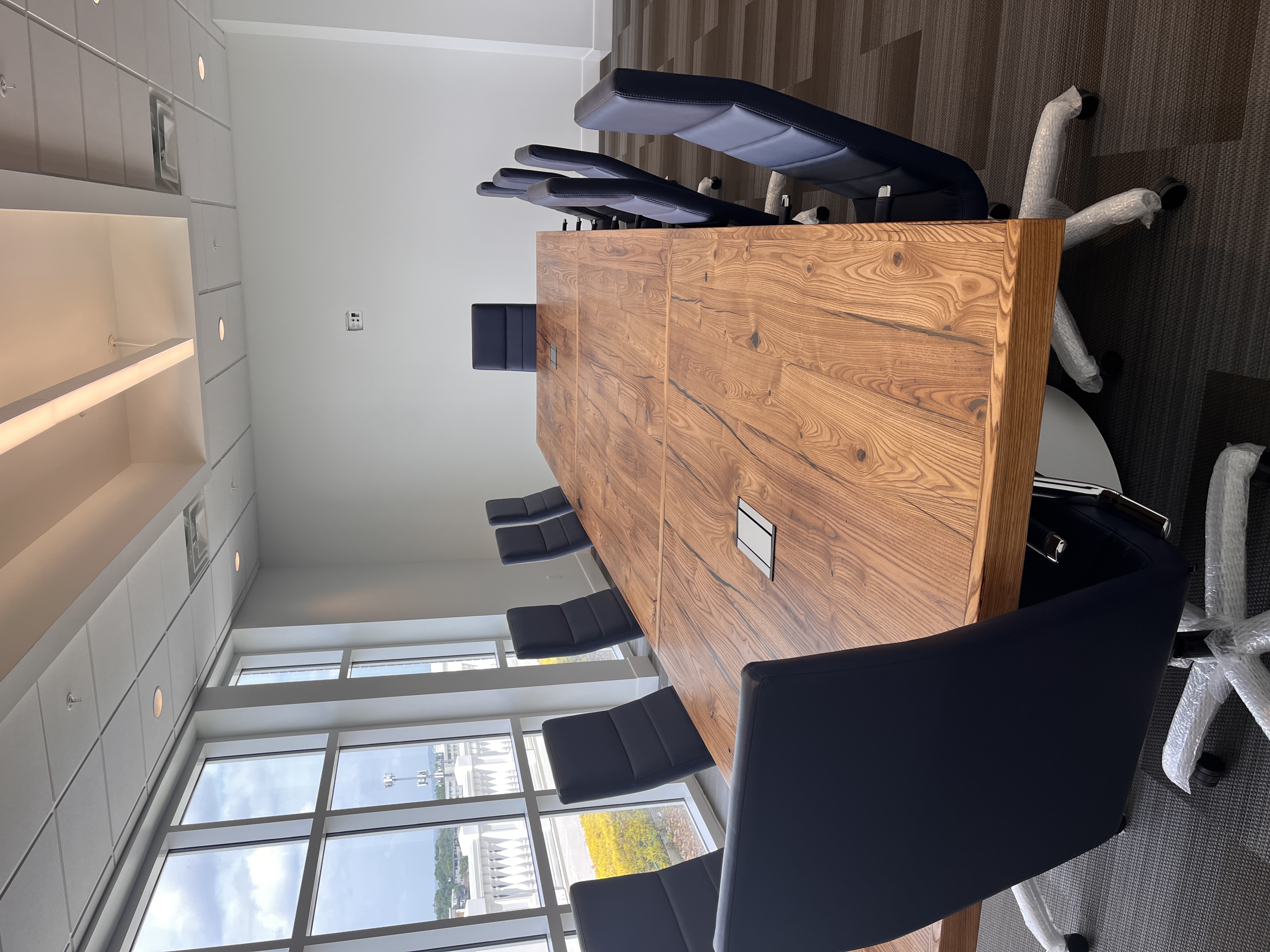 Photo of the chestnut table with chairs lined up around it