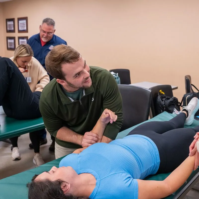 A physical therapy resident teaches a DPT student