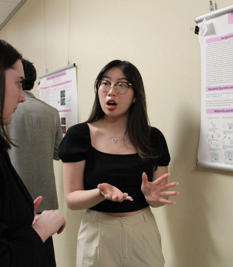 student giving a poster presentation