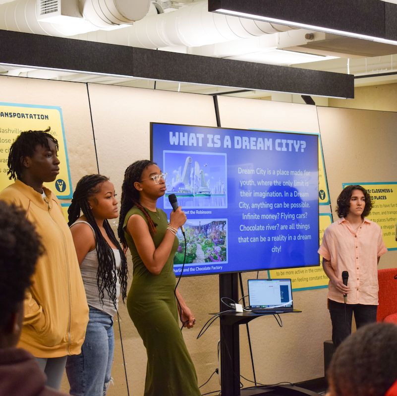 Four students from the Nashville Youth Design Team present in front of a screen