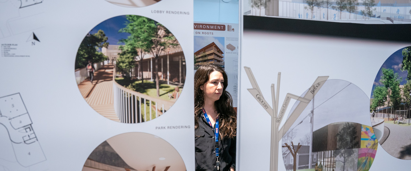 Person stands in the middle of architecture presentations