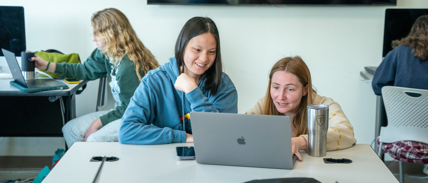 two students working on a computer