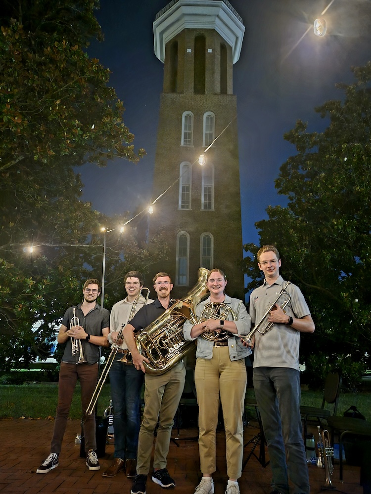 freddy and fellow musicians in front of bell tower at belmont