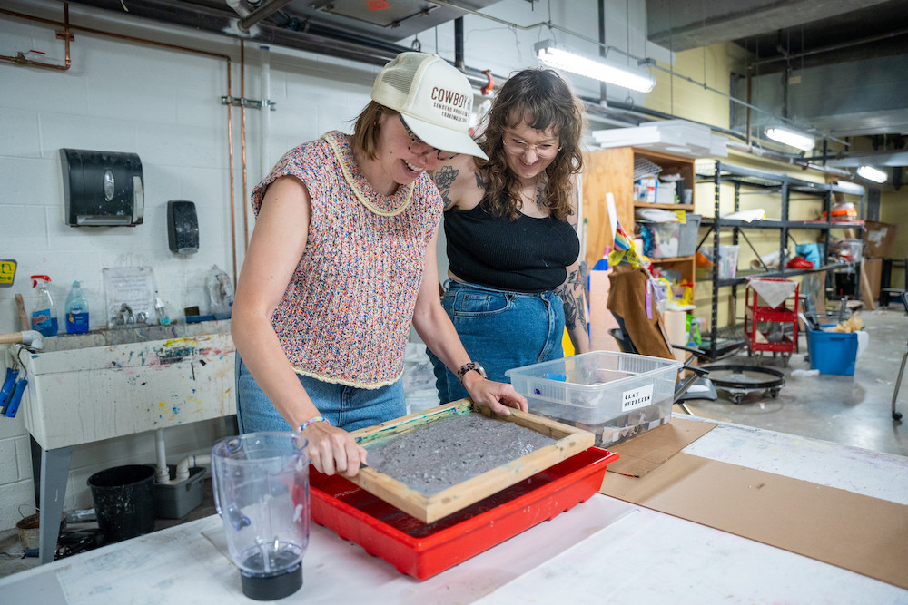 students work with materials in art studio