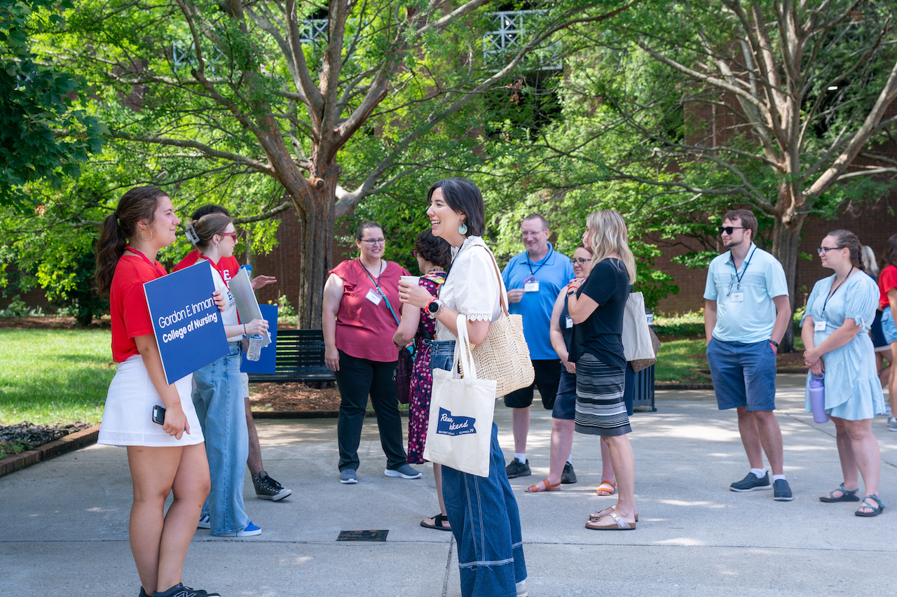 Group of people outside gathering for campus tours