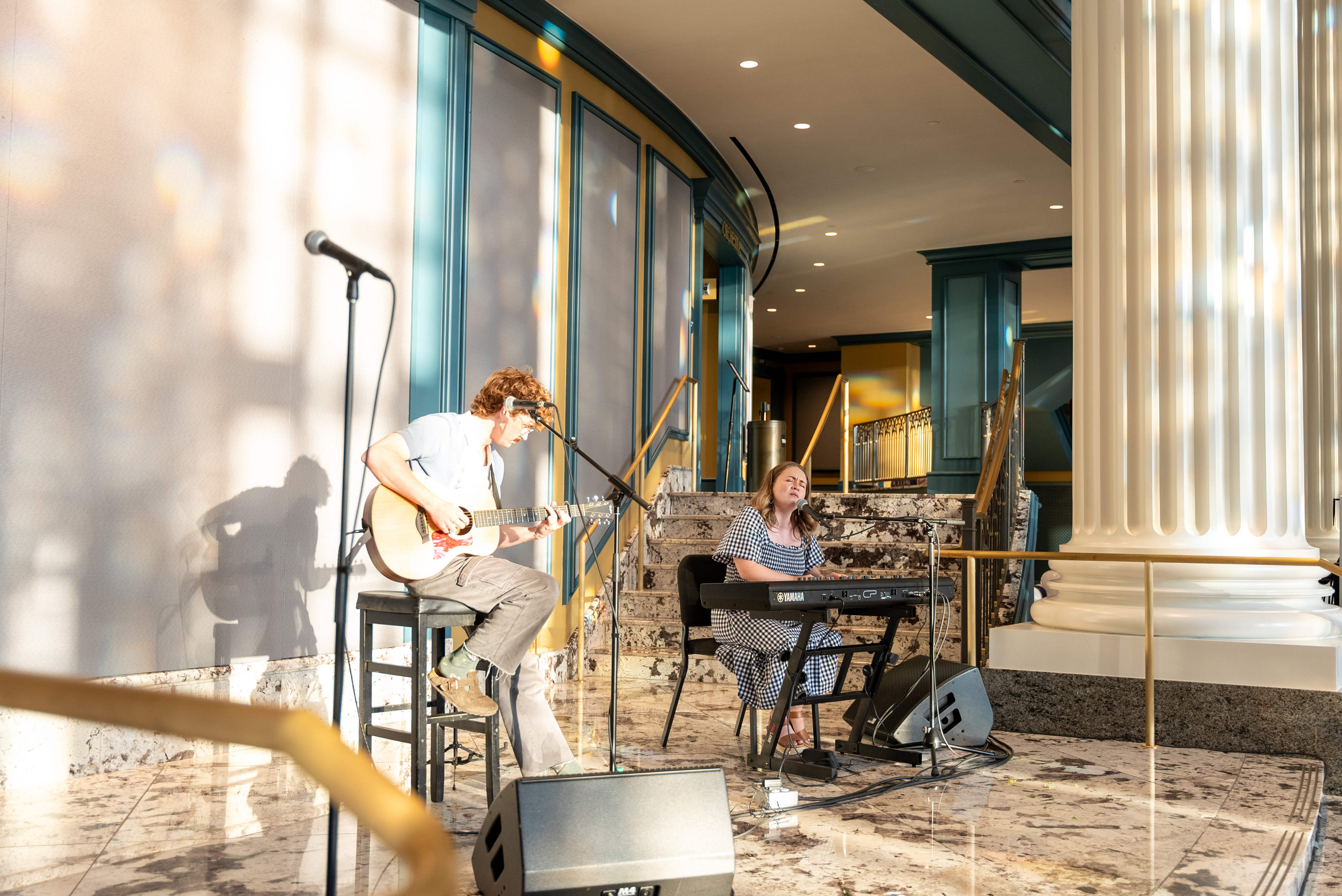 Two musicians singing in the Fisher Center