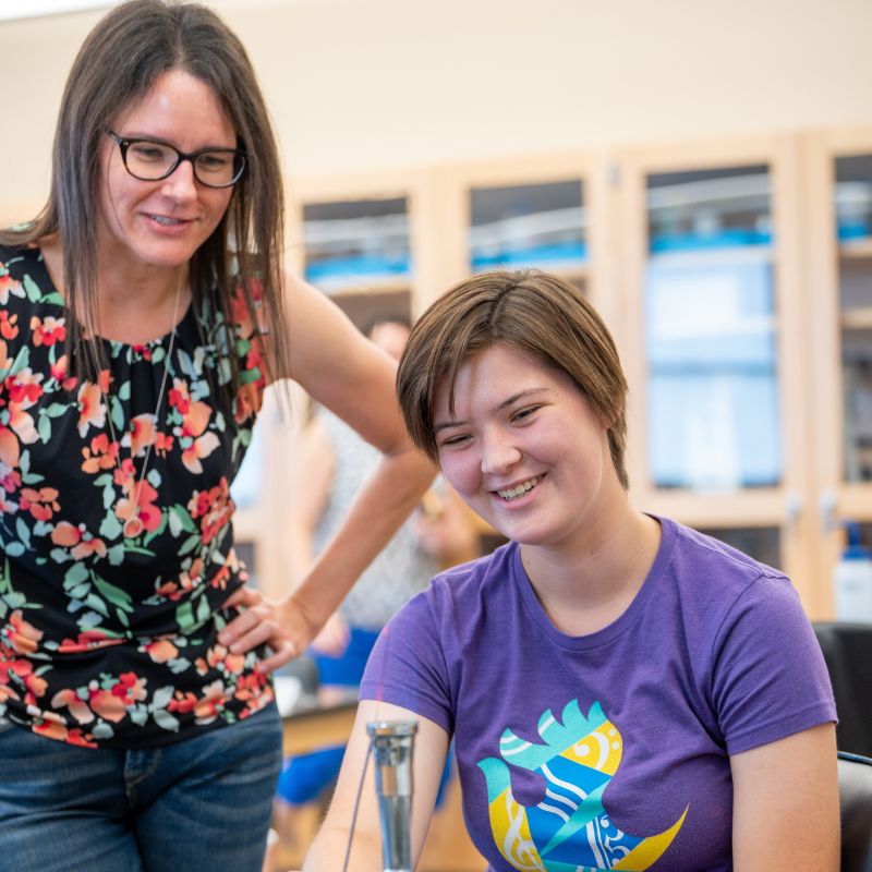 Dr. Adams alongside a student at VISIBL