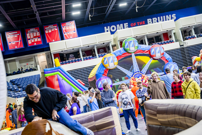 Students enjoying inflatable obstacle course