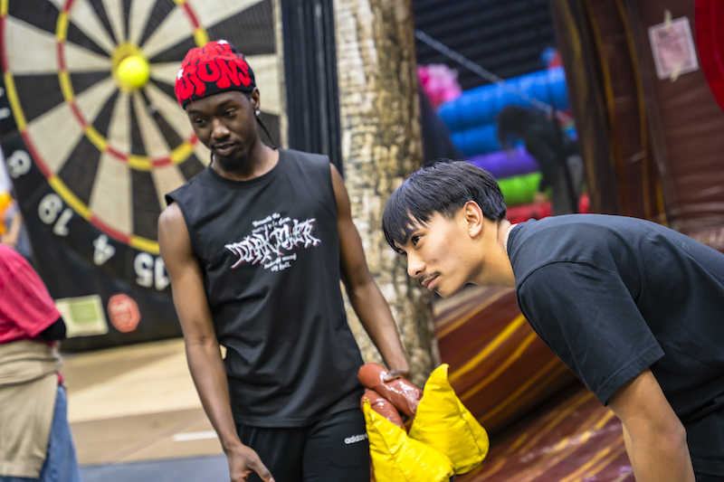 Students playing inflatable ax throwing
